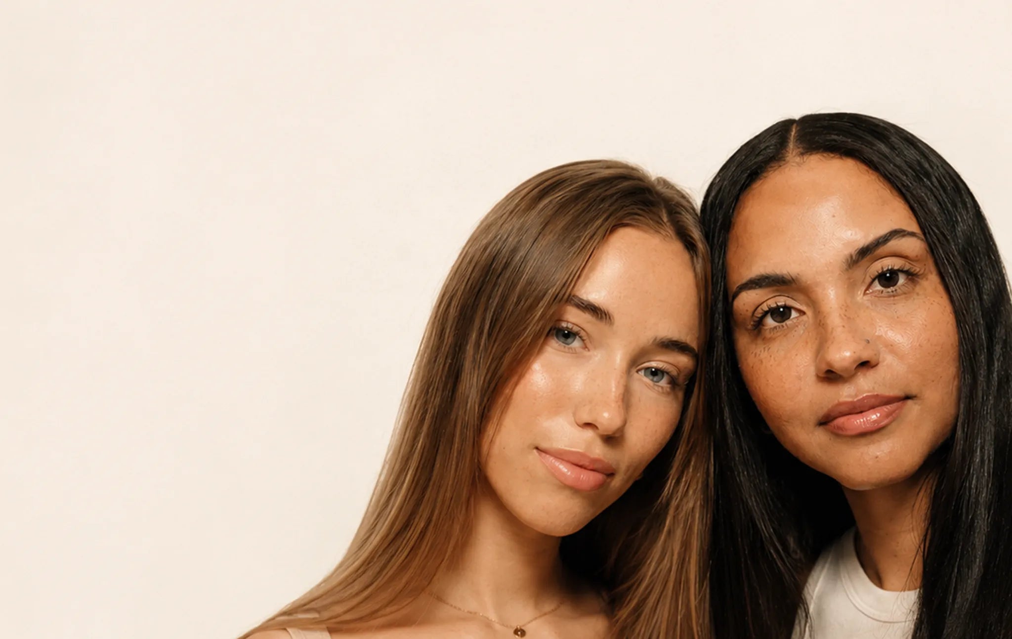 Two women with clear, glowing skin side by side